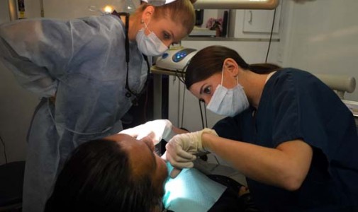 Dr. Ann Marie Maggio, attending dentist, checks resident Dr. Ashley Orth’s patient.