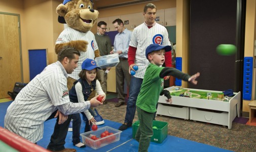 The Chicago Cubs’ new mascot, Clark, and prospects Mike Olt and Albert Almora play a ball toss game with the kids.