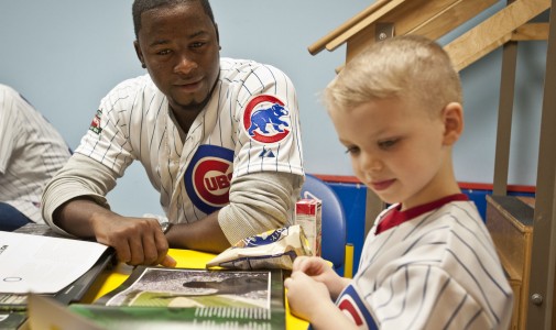 Cubs prospect Arodys Vizcaino looks through a Wrigley Field book with this little guy.