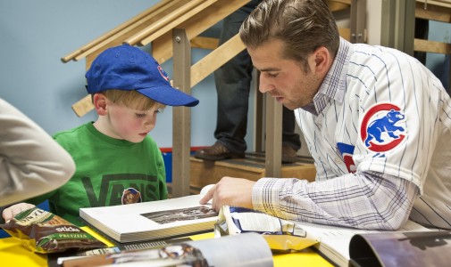 Cubs prospect Mike Olt gets in some reading time with one little boy.
